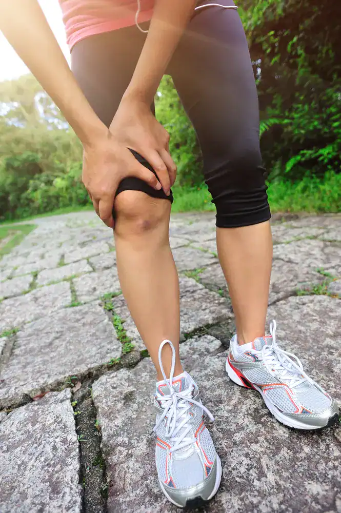 Woman grabbing knee in pain